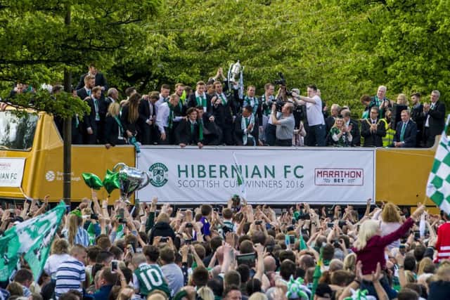 The Hibernian squad celebrate with the William Hill Scottish Cup as they parade through Edinburgh on an open-top bus. Picture: SNS