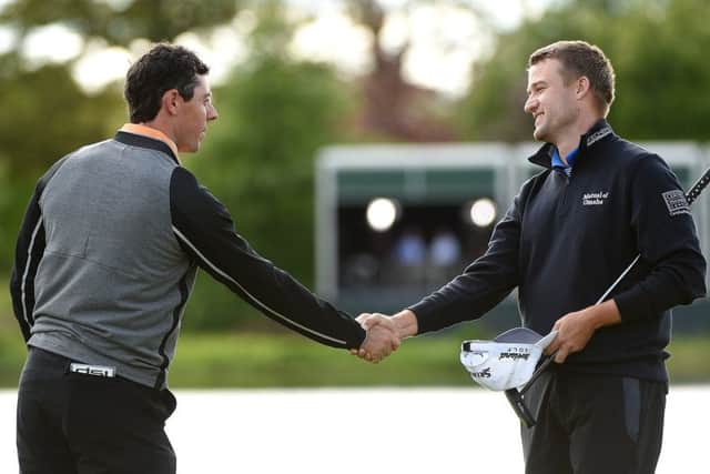 After winning his home event in thrilling style, Rory McIlroy, left, shakes hands with Scotlands Russell Knox. Picture: Getty