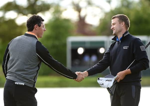 After winning his home event in thrilling style, Rory McIlroy, left, shakes hands with Scotlands Russell Knox. Picture: Getty