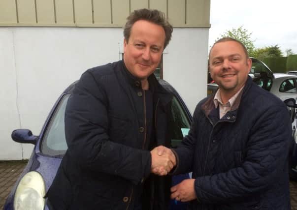 Used car dealer Iain Harris, right, and Prime Minister David Cameron. Picture: PA