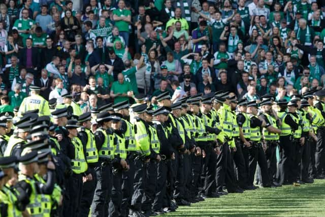 Police on the field at Hampden. Picture: Robert Perry