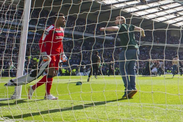 Rangers goalkeeper Wes Foderingham (left) with a Hibernian fan at full-time in the Scottish Cup final. Picture: SNS