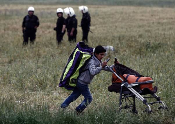 A boy moves his belongings during an evacuation operation at the Greek-Macedonian border near the village of Idomeni. Picture: AFP/Getty Images