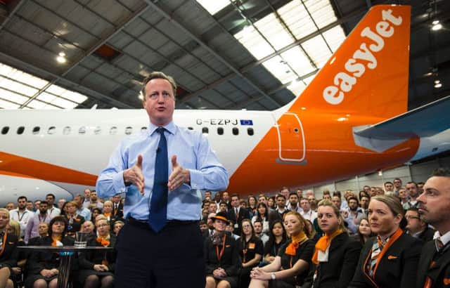 David Cameron stands in front of an aircraft as he delivers a speech inside a hangar at low-cost airline EasyJet's headquarters in Luton, north of London. Picture: PA