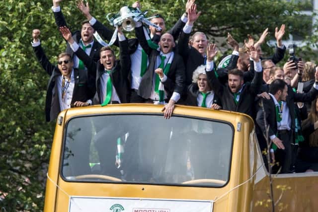 Hibs are welcomed home with the Scottish Cup on their open-topped bus. Picture: SNS.