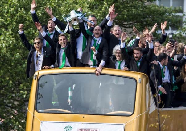 Hibs are welcomed home with the Scottish Cup on their open-topped bus. Picture: SNS.