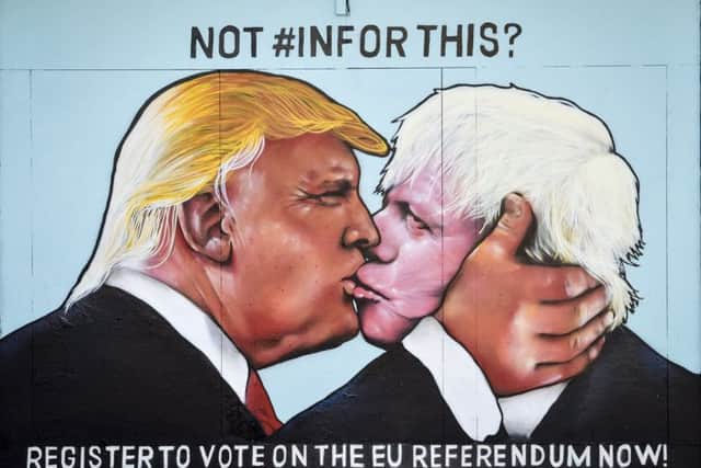 A graffiti mural of Donald Trump and Boris Johnson kissing, sprayed on a disused building in the Stokes Croft area of Bristol. Picture: PA
