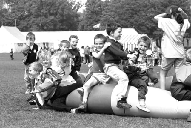 Children playing on the inflatables at the Scottish International Children's Festival held in Inverleith Park, Edinburgh, May 1992.