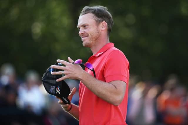 Danny Willett, on the 18th green, is pleased with his round of 66. Picture: Getty