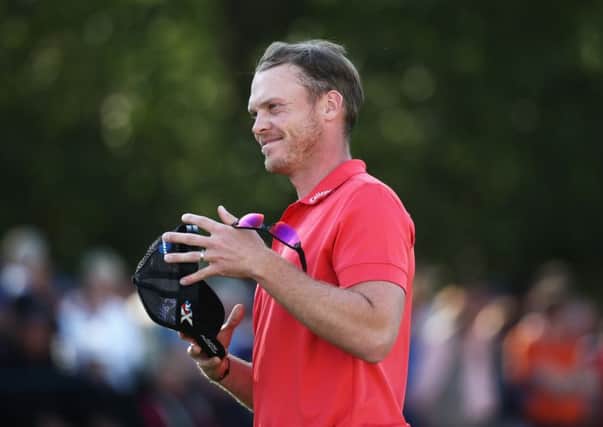 Danny Willett, on the 18th green, is pleased with his round of 66. Picture: Getty