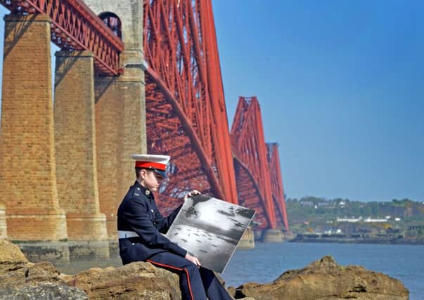 Sea Cadet Ethan Megson from South Queensferry studies a picture of the Grand Fleet  in the Firth of Forth in 1916. Picture: Jon Savage
