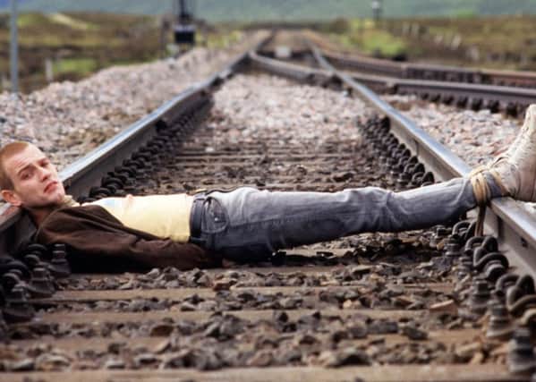 Ewan McGregor lying across the track at Corrour in the scene from the classic film. Picture: Kobal