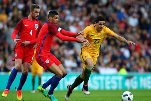 Australia's Tom Rogic holds off pressure from England's Chris Smalling. Picture: Getty Images