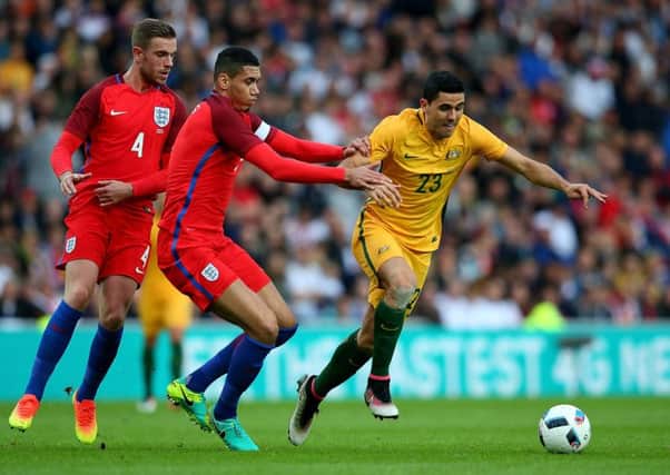Australia's Tom Rogic holds off pressure from England's Chris Smalling. Picture: Getty Images
