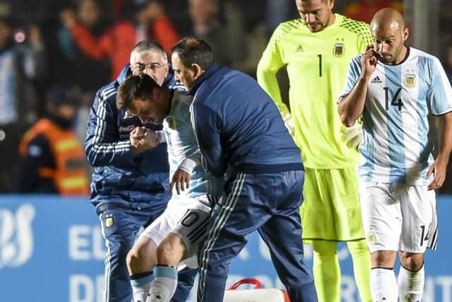 Lionel Messi is helped off after being injured against Honduras. Picture: Eitan Abramovich/AFP/Getty Images