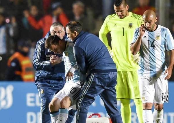 Lionel Messi is helped off after being injured against Honduras. Picture: Eitan Abramovich/AFP/Getty Images