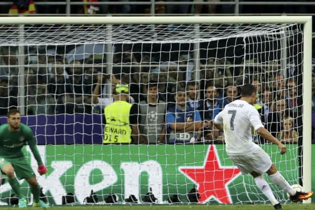 Real Madrid's Cristiano Ronaldo scores the decisive penalty in the 5-3 shoot-out win over Atletico Madrid. The match finished 1-1. Picture: Luca Bruno/AP