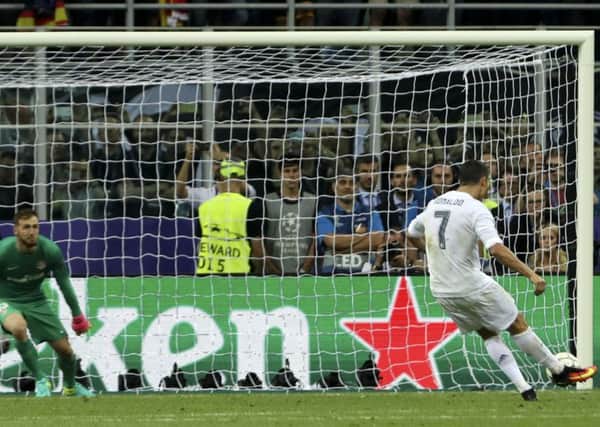 Real Madrid's Cristiano Ronaldo scores the decisive penalty in the 5-3 shoot-out win over Atletico Madrid. The match finished 1-1. Picture: Luca Bruno/AP