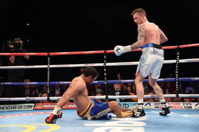 Ricky Burns, right, knocks down Michele Di Rocco on his way to winning the vacant WBA World Super-Lightweight title in Glasgow. Picture: Rob Casey/SNS Group