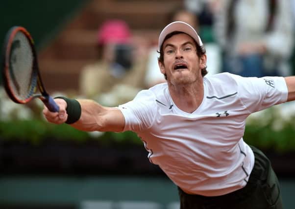 Andy Murray stretches to make a forehand return against American John Isner at Roland Garros yesterday. Picture: AFP/Getty Images