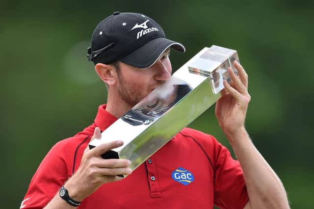 Chris Wood kisses the trophy after winning the BMW PGA Championship at Wentworth by one shot from Swedens Rikard Karlberg.