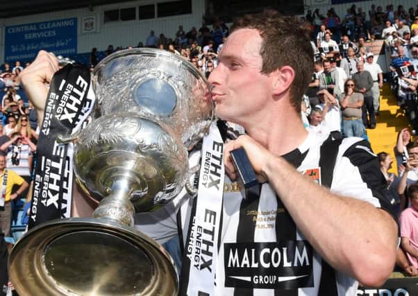 Richard Burke, scorer of the decisive penalty, with the trophy. Picture: SNS Group