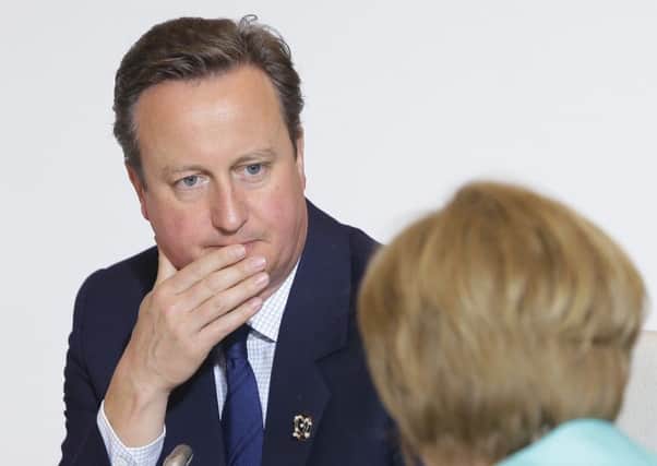 Prime Minister David Cameron talks with German Chancellor Angela Merkel at the G7 summit in Japan. Picture: Getty Images