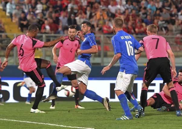 Italy's Graziano Pellè (centre) vies for the ball with Scotland's Matt Phillips (left). Picture: AP