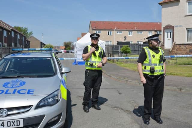 Police at the cordoned off area in Tweed Avenue where Mr Adie was found. Picture: George McLuskie