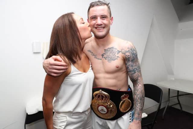 Three-weight champion Ricky Burns with wife Amanda after his world-title victory on Saturday.