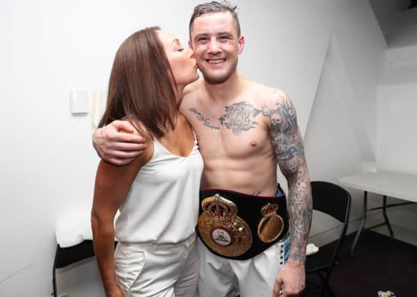 Three-weight champion Ricky Burns with wife Amanda after his world-title victory on Saturday.