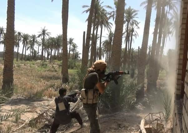 IS fighters battle Iraqi forces and their allies west of Fallujah. Picture: AP