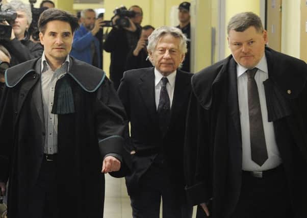 Roman Polanski, centre, with his lawyers in Krakow, Poland. Picture: AP