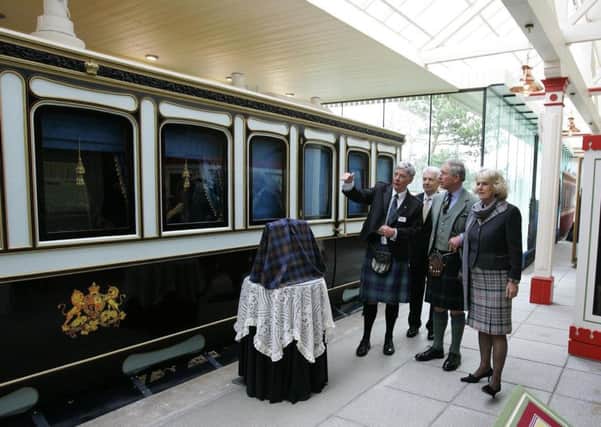 The Prince of Wales and Duchess of Cornwall receiving a talk from railway staff about the reproduction Victorian railway carriage at Ballater's Old Royal Station in 2008. Picture: PA
