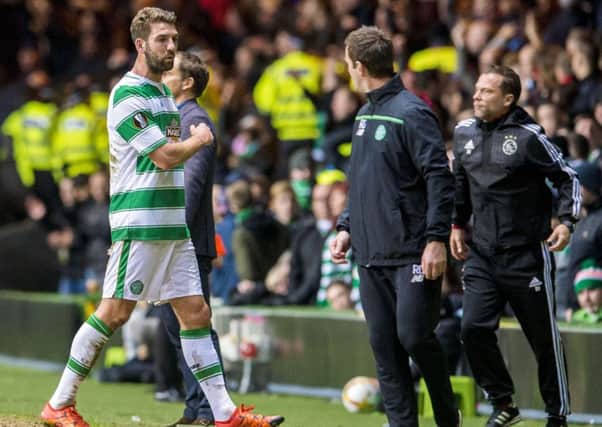 Injury forces Charlie Mulgrew to  leave the field in Celtics 2-1 home defeat by Ajax. Picture: SNS.