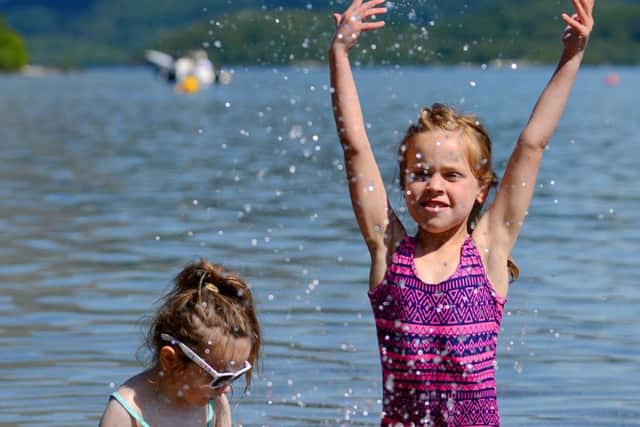 Sisters Olivia (right) and Nieve, aged six and four enjoy splashing along the shores of Loch Lomond.
