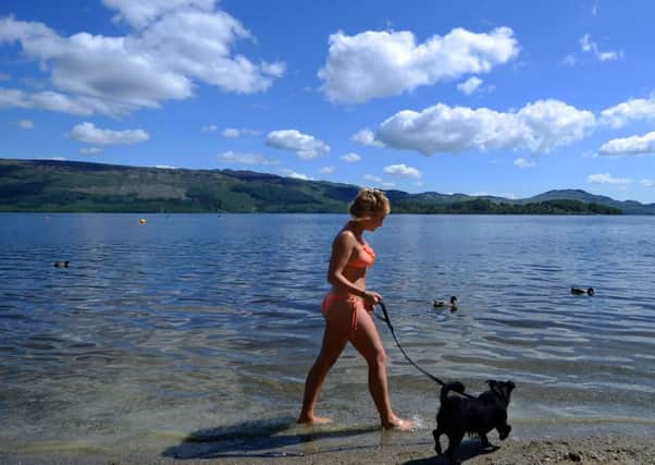 Shannon Hopkirk, aged 20, walks her dog along the shores of Loch Lomond. Picture: SWNS