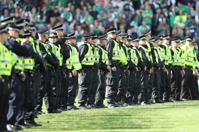 Police formed a cordon after Hibs fans invaded the pitch following the Scottish Cup final win over Rangers. Picture: Ian MacNicol/Getty