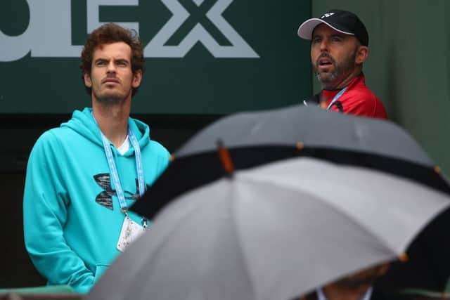 Andy Murray and coach Jamie Delgado look on as the rain threatens against in Pari. Picture: Clive Brunskill/Getty Images