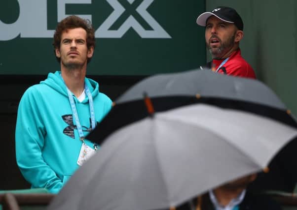 Andy Murray and coach Jamie Delgado look on as the rain threatens against in Pari. Picture: Clive Brunskill/Getty Images
