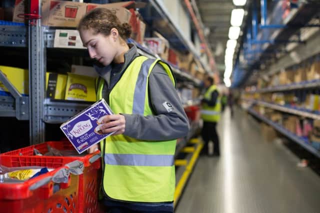 A staff member packing food in a Customer Fulfilment Centre in Hatfield, as over a tenth of Britons have turned solely to online grocery shopping and home delivery, figures show. Picture: PA