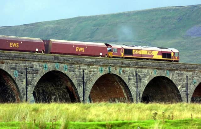 An EWS freight train passes over the Ribblehead viaduct in Cumbria on the Carlisle to Settle railway line. Picture: PA