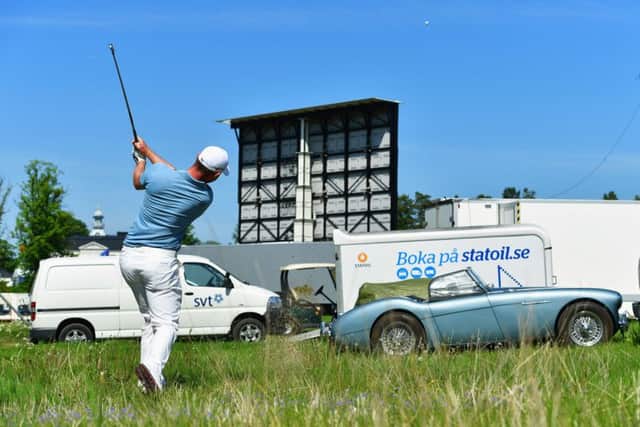 Scott Henry plays his second shot at 18th hole from a car park in the first round of the Nordea Masters. Picture: Getty Images