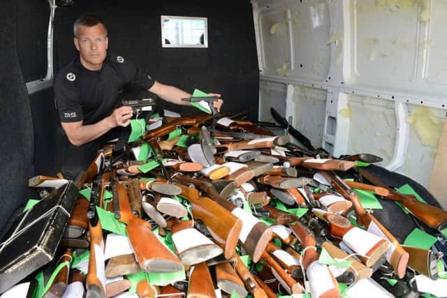 Assistant chief constable Mark Williams shows some of the 2301 weapons which have been surrendered during the first week of a three-week Air Weapons Surrender Campaign. Picture: SWNS