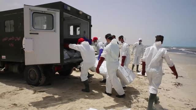Emergency services remove the body of a victim as more than 100 bodies are pulled from the sea near the western city of Zwara, Libya, Picture: AP