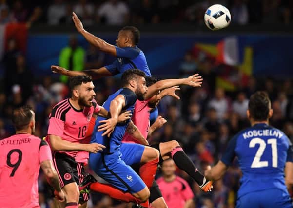 France's Olivier Giroud and Patrice Evra challenge for the ball which fell to Laurent Koscielny, right, who headed home the third goal. Franck Fife/AFP/Getty Images