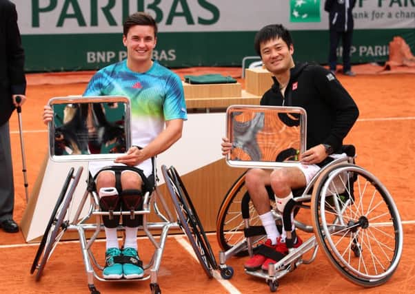 Consolation for Gordon Reid and Shingo Kunieda as they pose with their Men's Wheelchair doubles trophies. Picture: Getty Images