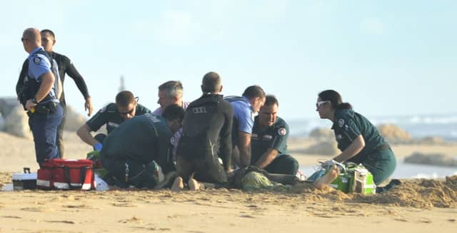 Ambulance and police officers helped surfer Ben Gerring after a shark ripped off his leg in an attack. Picture: Getty