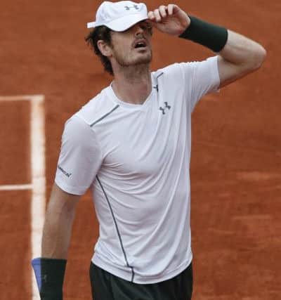 Andy Murray pulls his cap over his head after missing a return from Djokovic. Picture: AP