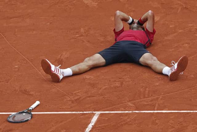 Novak Djokovic celebrates  victory before consoling Andy Murray and high-fiving ballboys and girls on his way to being presented with  the trophy. Picture: PA